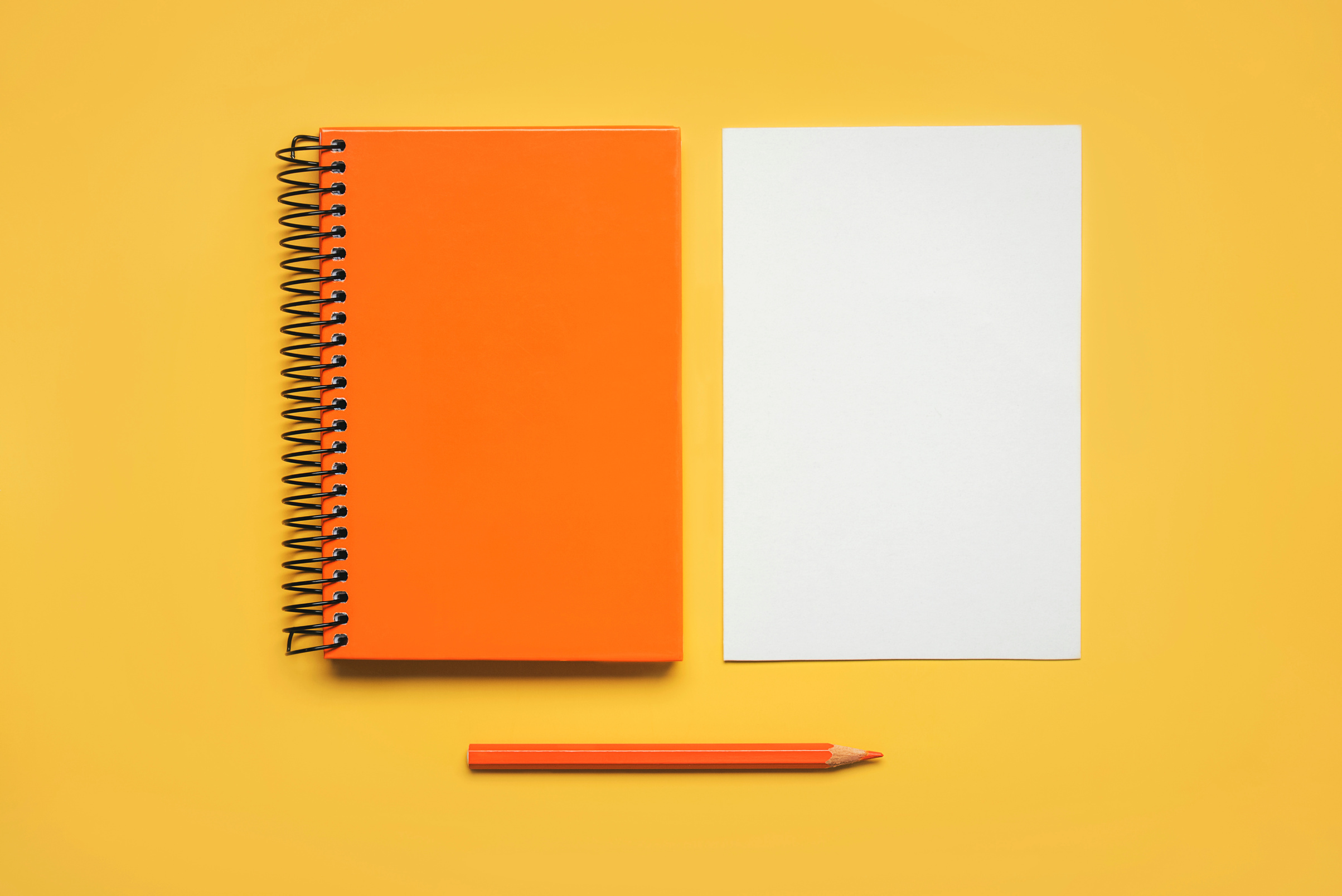 Open Orange Spiral Notepad with Pencil